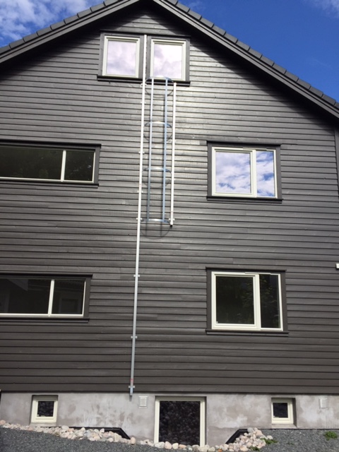 A emergency escape ladder reaching the top of a home
