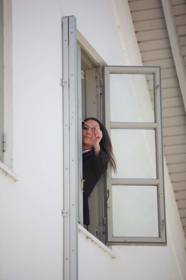 A woman unfolding a Modum emergency fire escape ladder