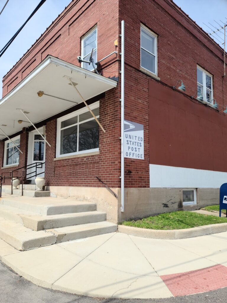A side view of a post office with emergency fire escape ladder
