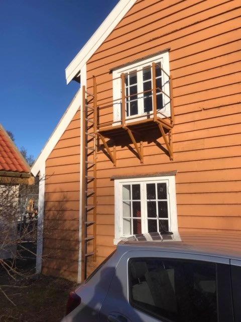 A side view of a house with emergency fire escape ladder